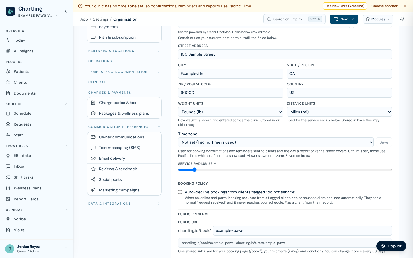 Clinic profile with the Time zone field set to Not set, and the amber banner above asking to choose a time zone